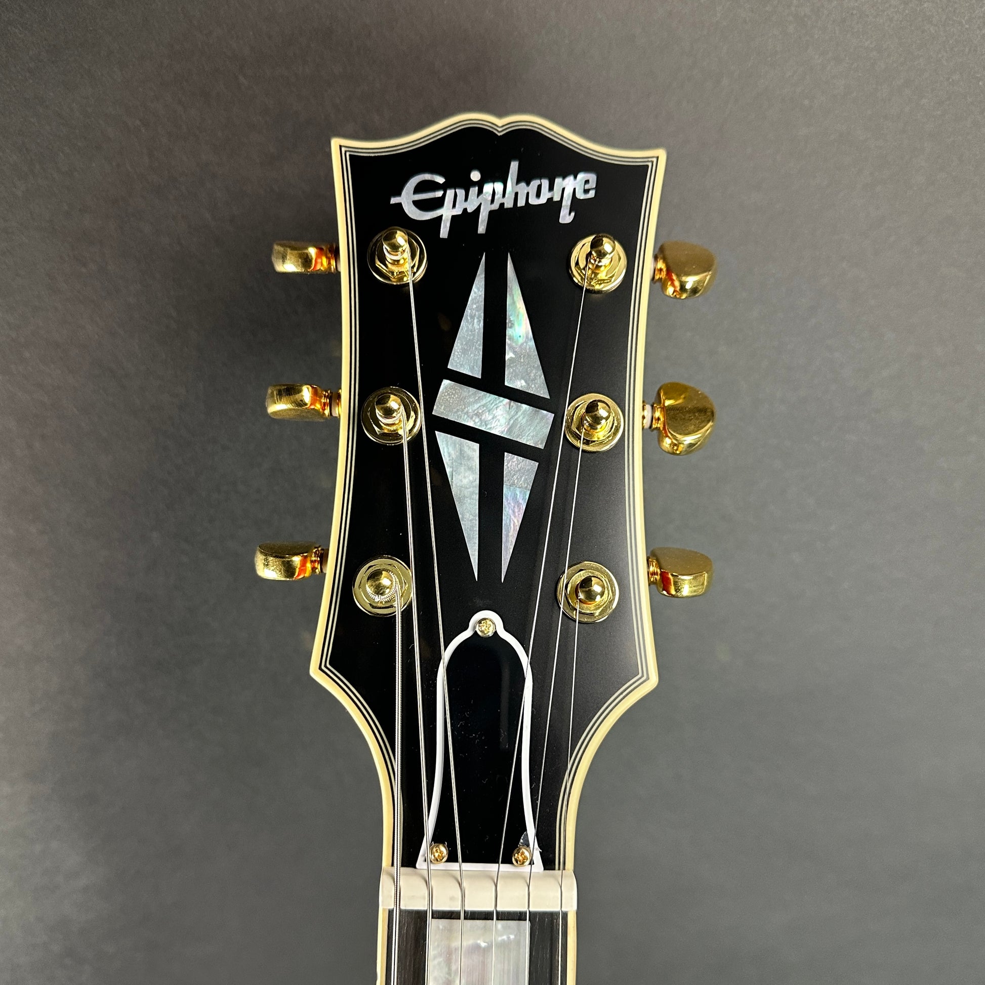 Front of headstock of Used Epiphone "Inspired by Gibson" Custom 1959 ES-355 Cherry Red.