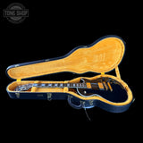 Guitar in an open case with 'Tone Shop' logo in the corner