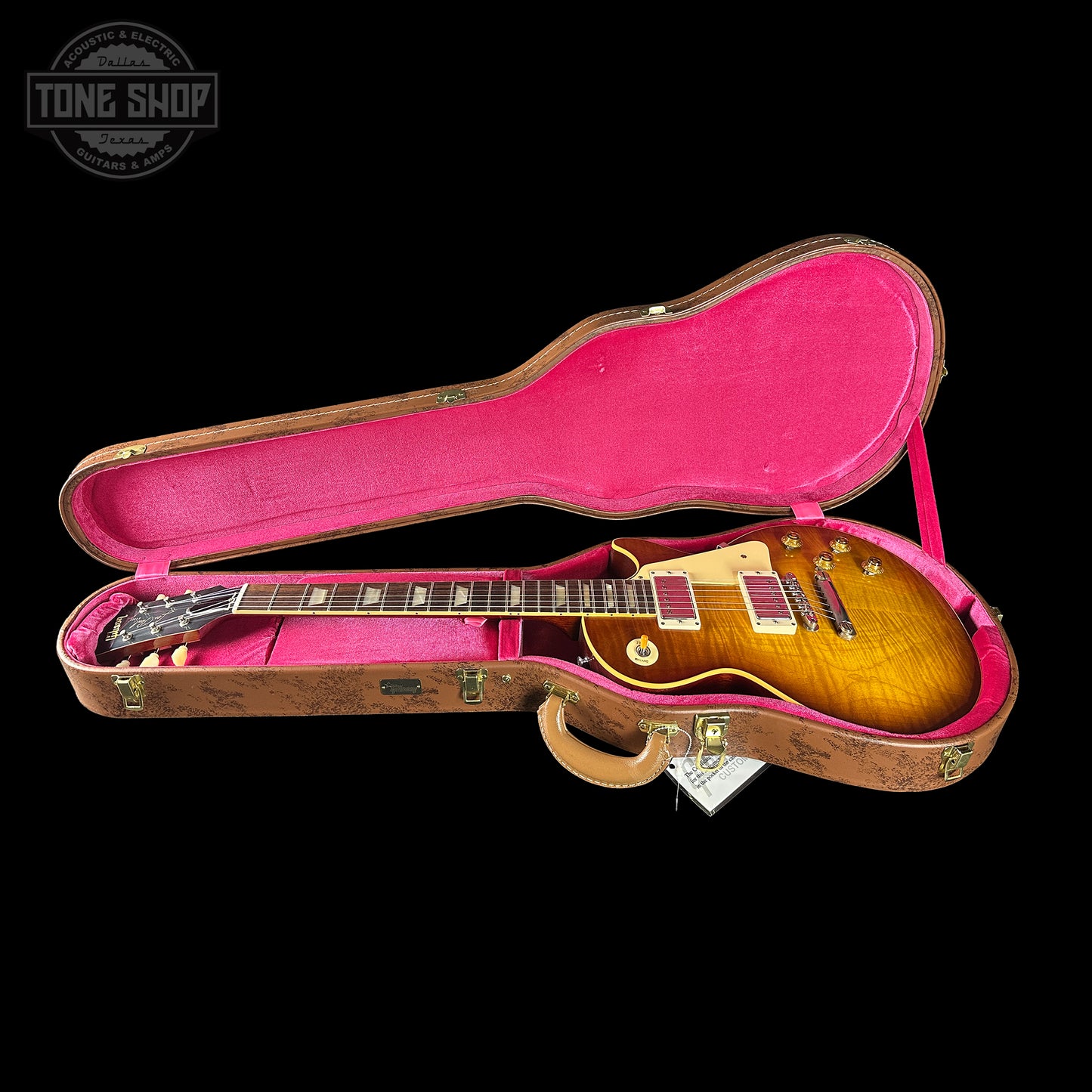 Gibson Les Paul guitar in a pink case with 'Tone Shop' logo.