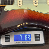 Guitar on a digital scale displaying weight