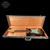Guitar in an open case with a visible brand logo on a black background