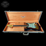 Fender electric guitar in an open case with Fender logo.