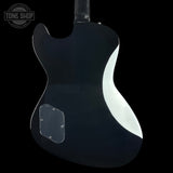 Glossy black electric guitar on a black background with 'Tone Shop' logo.