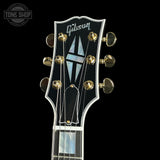 Gibson guitar headstock with brand logo on a black background
