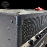 Close-up of a guitar amplifier with 'Tone Shop' logo in the corner.