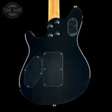 Black electric guitar with clear pickguard on a black background, featuring 'Tone Shop' logo.