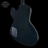 Black electric guitar body on a black background with 'Tone Shop' logo.