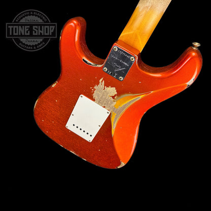 Back angle of Fender Custom Shop Limited Edition 62 Strat Heavy Relic Aged Candy Tangerine Over 3 Color Sunburst.