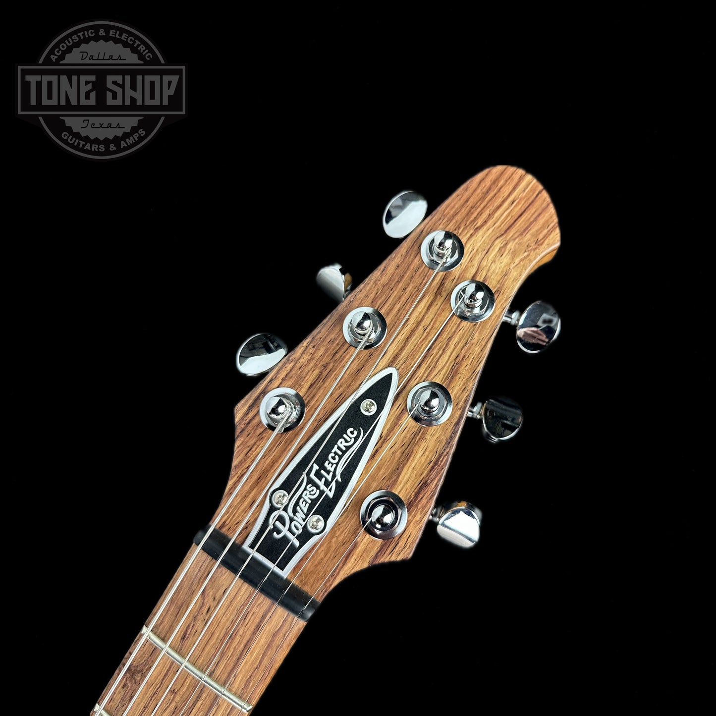 Front of headstock of Powers Electric A-Type Select Maple Pale Ale PF42 Firestripe Brass Warm CamTail.