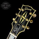 Front of headstock of on Custom Shop M2M Les Paul Custom Antique Silver Murphy Lab Light Aged GH.