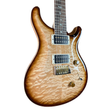 Electric guitar with a quilted maple top on a white background