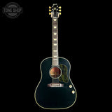 A dark teal acoustic-electric guitar with gold hardware and a green-and-black zebra-patterned pickguard, shown against a solid black background with a Tone Shop watermark in the top-left corner.