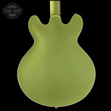 Green electric guitar body on a black background with 'Tone Shop' logo.