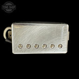 Silver pickup with six screws on a black background, featuring the Tone Shop logo.