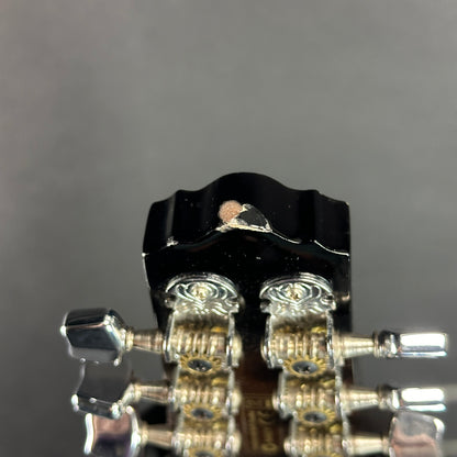 Chip on headstock of Used Ibanez M510E Mandolin.