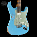 A light blue electric guitar with a heavily distressed, worn finish and a pale mint green pickguard, shown against a solid black background. A Tone Shop watermark is visible in the top-left corner.