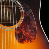Close-up of an acoustic guitar's soundhole and strings on a black background