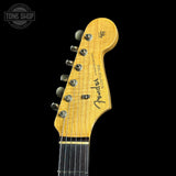Guitar headstock with Fender logo on a black background