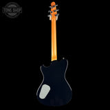 Black electric guitar with a visible brand logo on a black background