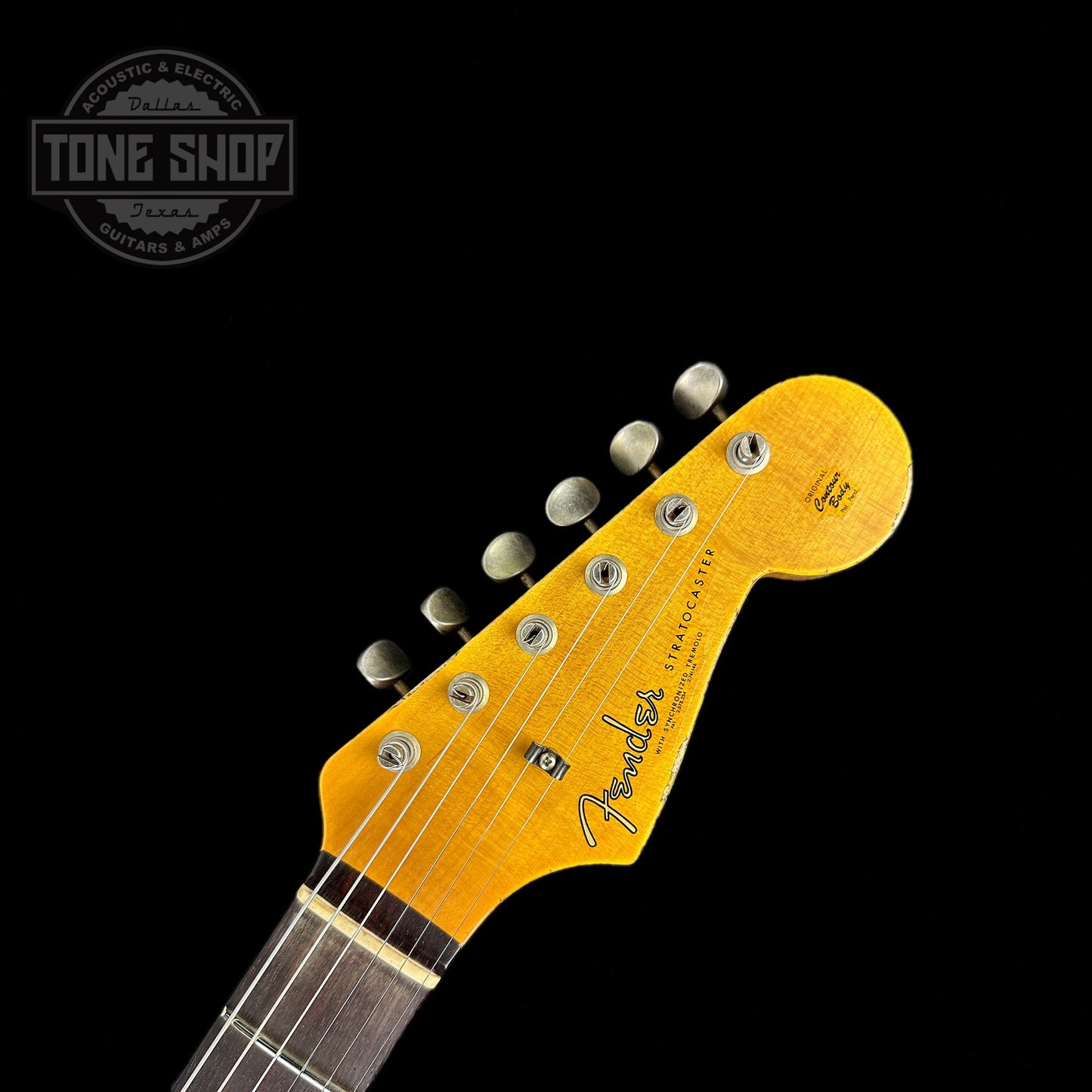 Front of headstock of Fender Custom Shop Limited Edition 62 Strat Heavy Relic Aged Candy Tangerine Over 3 Color Sunburst.