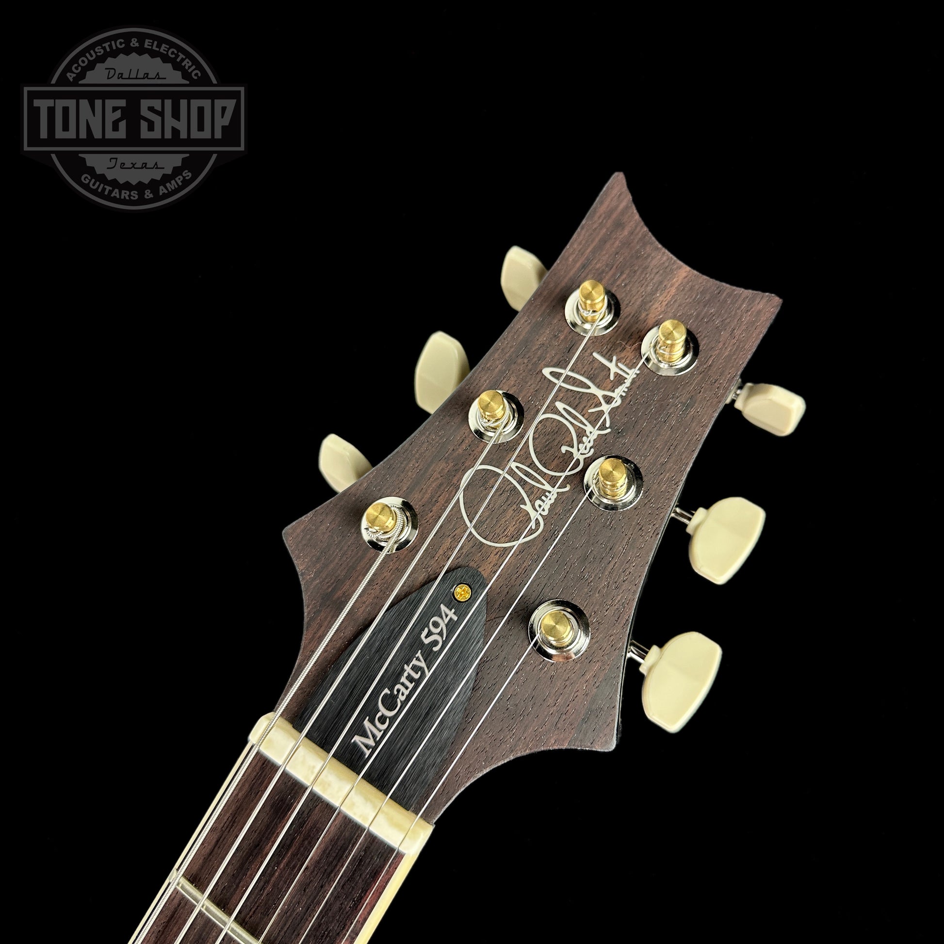Front of headstock of PRS McCarty 594 Flame Maple 10 top Charcoal Burst.