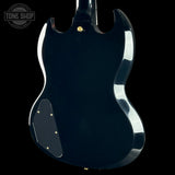 Back view of a black electric guitar with 'Tone Shop' logo.