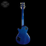 Blue electric guitar on a black background with 'Tone Shop' logo.