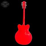 Red electric guitar on a black background with 'Tone Shop' logo.