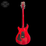 Back of Custom 24 Red electric guitar on a black background with 'Tone Shop' logo.