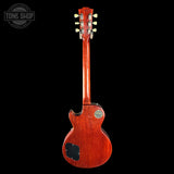 Back view of a red electric guitar on a black background with 'Tone Shop' logo.