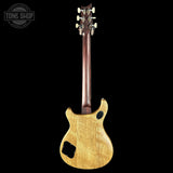 Back view of a wooden electric guitar with a visible brand logo in the corner.