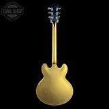 Gold electric guitar on a black background with 'Tone Shop' logo.