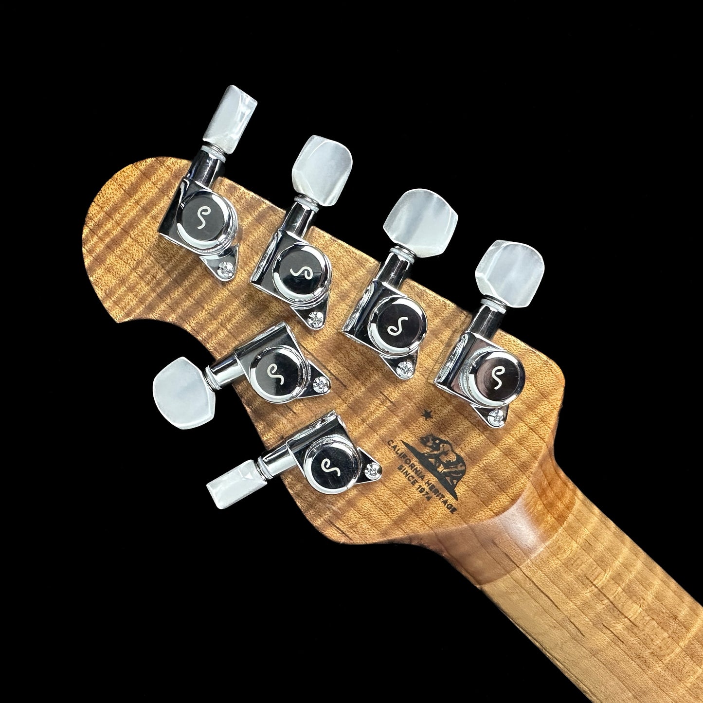 Back of headstock of Ernie Ball Music Man BFR JP15 Butterscotch Burl.