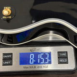 Digital kitchen scale with a gloved hand pressing a button, displaying weight measurement.