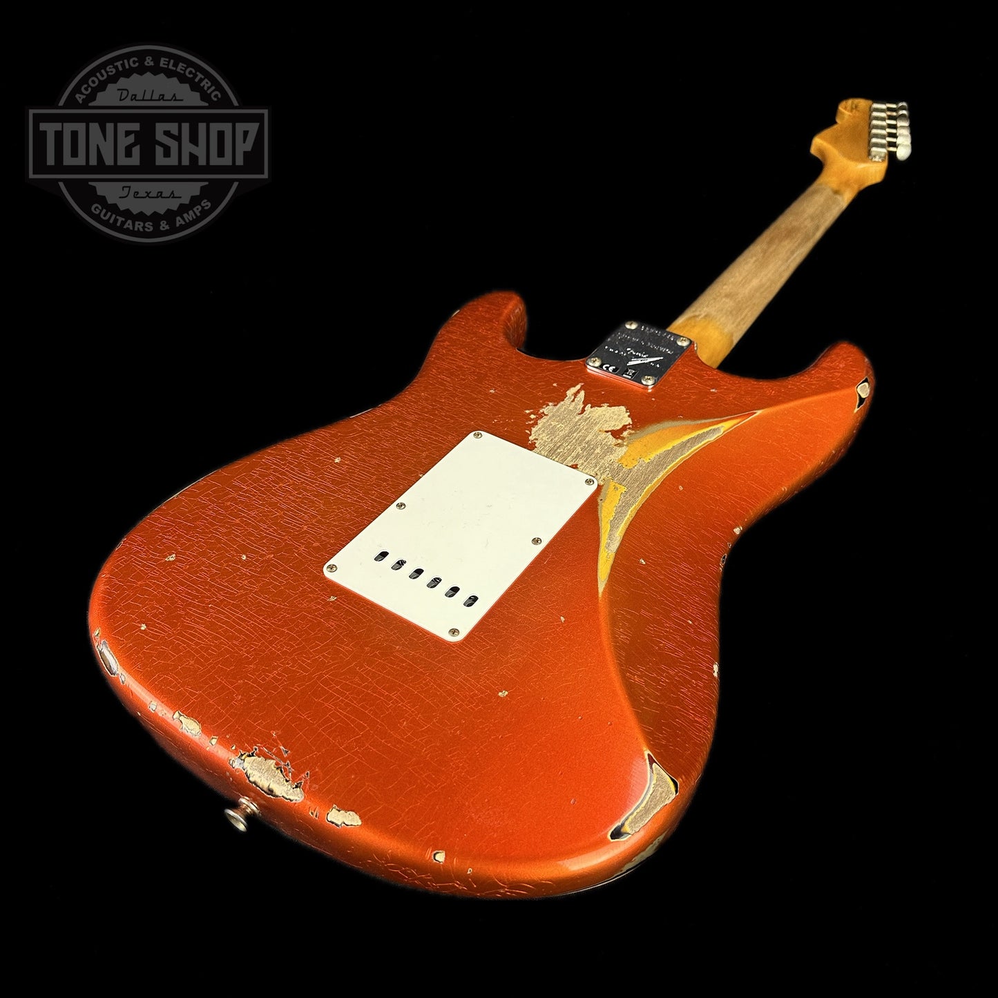 Back angle of Fender Custom Shop Limited Edition 62 Strat Heavy Relic Aged Candy Tangerine Over 3 Color Sunburst.