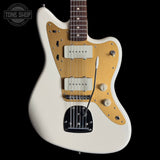 Squier J Mascis Jazzmaster Olympic White electric guitar with a blonde fretboard on a black background, featuring 'Tone Shop' branding.