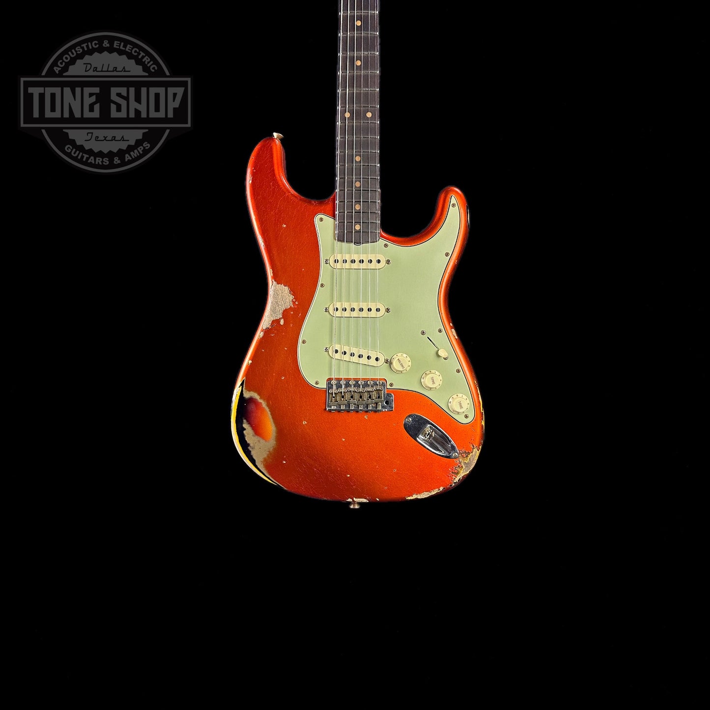 Front of body of Fender Custom Shop Limited Edition 62 Strat Heavy Relic Aged Candy Tangerine Over 3 Color Sunburst.