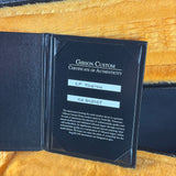Gibson Custom Certificate of Authenticity on a yellow textured background