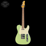 Green electric guitar with a white pickguard on a black background, featuring the Tone Shop logo.