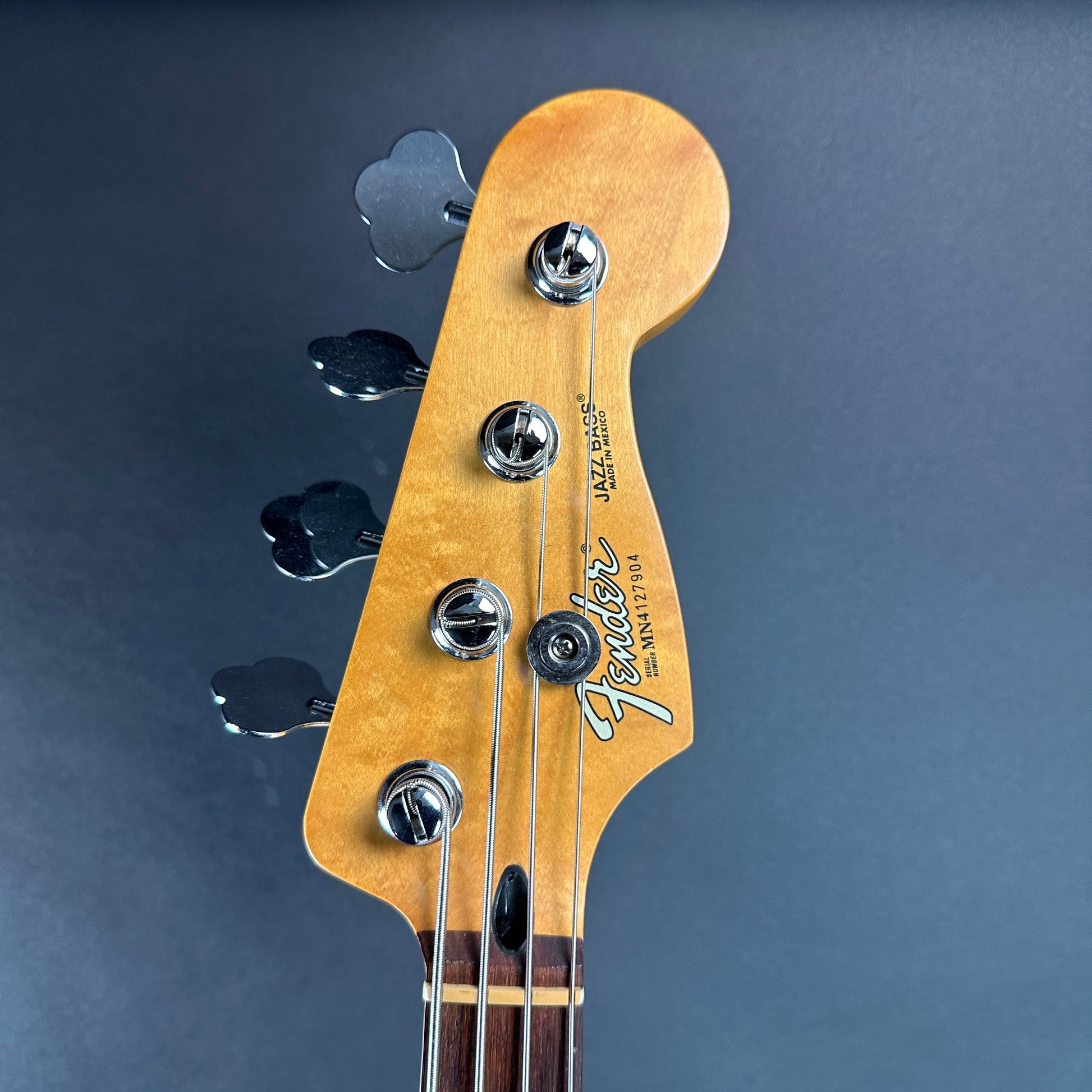 Front of headstock of Used Fender Jazz Bass MIM Sunburst.