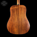 Back view of a mahogany acoustic guitar with 'Tone Shop' logo in the corner.
