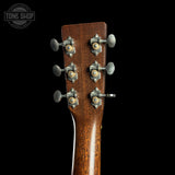 Close-up of a guitar headstock with tuning pegs on a black background, featuring 'Tone Shop' branding.