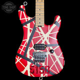 Guitar with red and white design on a black background, featuring the 'Tone Shop' logo.