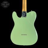 Green electric guitar body with a visible brand logo on a white background