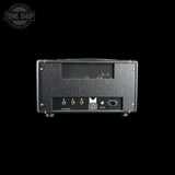 The rear view of a black textured guitar amplifier head against a solid black background, featuring input jacks, a power switch, and the Melodyne logo.