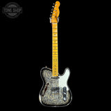 A Fender Telecaster-style electric guitar with a black and silver paisley patterned body, a white pickguard, and a yellow maple neck, shown against a solid black background. A 'TONE SHOP' watermark is visible in the top-left corner.
