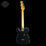 A black electric guitar shown from the back against a solid black background, with a yellow maple neck and headstock. A circular 'TONE SHOP' watermark is visible in the top-left corner.