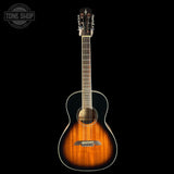 A classical acoustic guitar with a natural sunburst finish, shown vertically against a solid black background. The brand logo on the headstock is not clearly legible, and there is a 'TONE SHOP' watermark in the top-left corner.