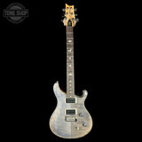 APRS electric guitar with a silver flamed maple top, black neck, and gold headstock, shown against a solid black background with a Tone Shop watermark in the top left corner.