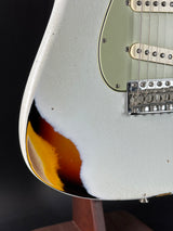 Close-up of a guitar's body with a focus on the pickguard and part of the neck.